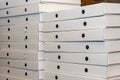 White cardboard boxes for pizza packaging on the counter in the pizzeria. Royalty Free Stock Photo