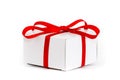 Christmas gift: white cardboard gift box with decorative red ribbon and tied bow isolated on a seamless white background Royalty Free Stock Photo