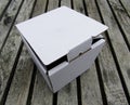 Cardboard mailing box on wooden deck