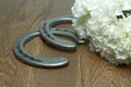 White Carnations for the Belmont Stakes with Horseshoes on Wood