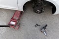 White cars change wheels using a lifting jack