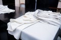 The white cassock of the priest lies on the table