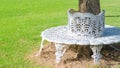 White cast iron chair built in circle around a tree