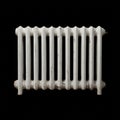 A white cast iron radiator on a black background Royalty Free Stock Photo