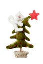 The white cat jumped on the Christmas tree. Soft toy isolated on white background. Christmas and New Year decor