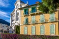 White cathedral and neighbor yellow house on streets of Monaco