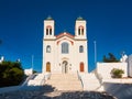 White Catholic church with staircase on sunny day