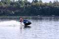 White, Caucasian attractive man on a blue water motorcycle