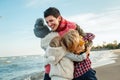 white Caucasian family, mother with three children kids hugging smiling laughing on ocean sea beach on sunset outdoors