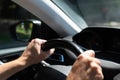 White caucasian men hands control a car steering wheel while driving on the road