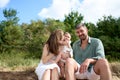 White Caucasian parents kissing their baby girl. Baltic sea, Latvia Royalty Free Stock Photo