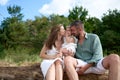 White Caucasian parents kissing their baby girl. Baltic sea, Latvia Royalty Free Stock Photo