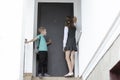 White Caucasian siblings, schoolchildren, elder sister and little brother come home from school together Royalty Free Stock Photo