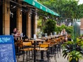 White Caucasian tourists drink beer at a deserted pub / bar at Resort World Sentosa, Singapore