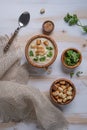 White cauliflower cream soup with croutons , spoon and herbs