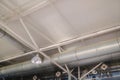 White ceiling with industrial metal pipes and support structures Royalty Free Stock Photo