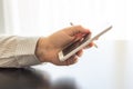 A man is holding a white cellphone and stylus in his hand. Royalty Free Stock Photo