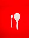 white centong and white spoon Red Background Royalty Free Stock Photo