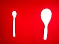 white centong and white spoon Red Background Royalty Free Stock Photo