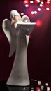 Ceramic angel statue with lights in background Royalty Free Stock Photo