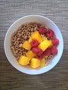 White Ceramic Bowl with Dry O Cereal, Raspberries and Mango Chunks Royalty Free Stock Photo