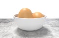 White ceramic bowl ful of eggs. Placed on concrete table. Royalty Free Stock Photo