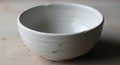White ceramic bowl with a slightly rough, textured surface, featuring horizontal ridges around its Royalty Free Stock Photo