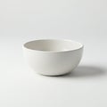 White ceramic bowl with a smooth finish placed against a uniform white background. Royalty Free Stock Photo