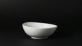 White Ceramic Bowl, Smooth Texture, Against a Dark Backdrop, Simple Still Life. Royalty Free Stock Photo