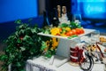 A white ceramic coaster with hors d`oeuvres on the wedding table.