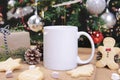 White ceramic coffee cup and christmas decoration on woon table background. mockup for creative advertising text message or