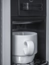 White ceramic coffee cup on coffee machine Royalty Free Stock Photo
