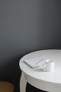 White ceramic coffee cup with notepad and pencil on white wooden table in scandinavian kitchen interior Royalty Free Stock Photo