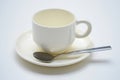 White ceramic coffee cup with saucer and spoon on a white background Royalty Free Stock Photo