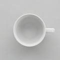A white ceramic coffee cup viewed from above on a matching light gray surface Royalty Free Stock Photo