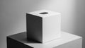 White ceramic cube with a smooth finish placed atop a gray square Royalty Free Stock Photo