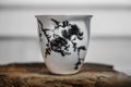 Ceramic cup for tea ceremony with hand painted flower pattern.