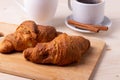 A white ceramic cup of black roasted coffee espresso and a french croissant Royalty Free Stock Photo