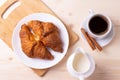 A white ceramic cup of black roasted coffee espresso and a french croissant Royalty Free Stock Photo