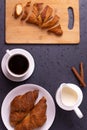 A white ceramic cup of black roasted coffee espresso and a french croissant Royalty Free Stock Photo