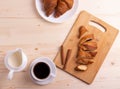 A white ceramic cup of black roasted coffee espresso and a french croissant Royalty Free Stock Photo