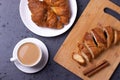 A white ceramic cup of black roasted coffee espresso and a french croissant Royalty Free Stock Photo