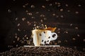 Coffee beans splashing on white cup with dark background