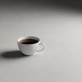White ceramic cup filled with black coffee, placed on a smooth gray surface Royalty Free Stock Photo