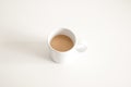 White ceramic cup of hot coffee with milk on a white wood table and refreshing look of the drink Royalty Free Stock Photo