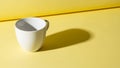 A contrast between the object and its shadow emphasizing the cup s Royalty Free Stock Photo
