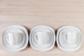 White ceramic cups and plates on wooden background, image