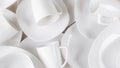 White ceramic cups and plates on wooden background, image