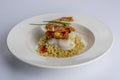 White ceramic dish with a delicious combination of couscous with fish and shrimp Royalty Free Stock Photo