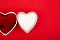 White ceramic hearts with red plush hearts on red background. Flat lay composition. Romantic, St Valentines Day concept.